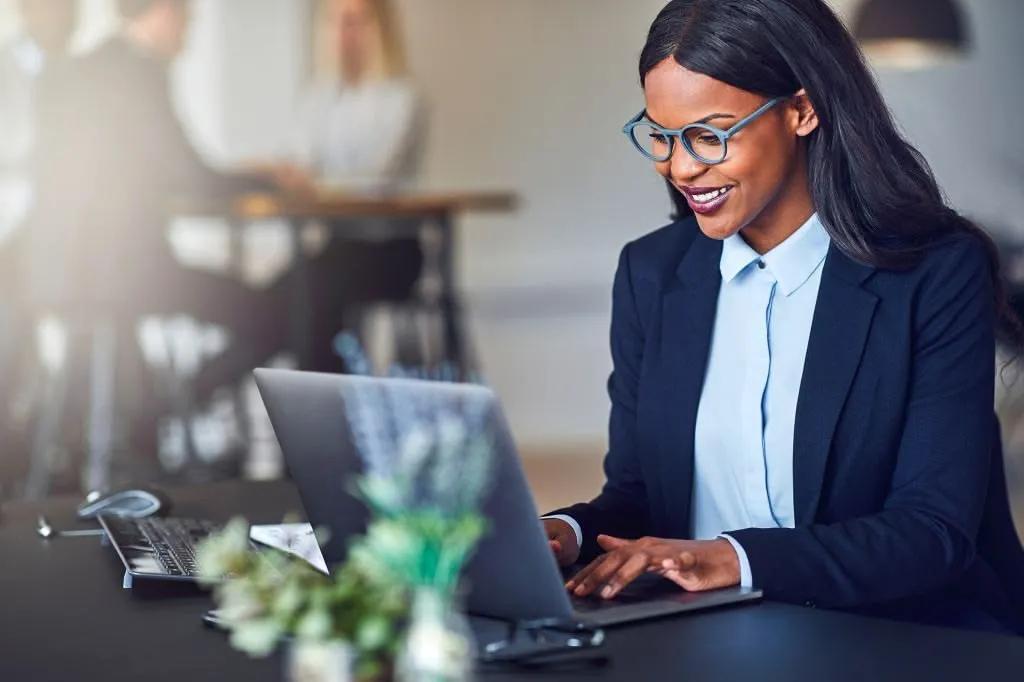 A finance professional working at her laptop
